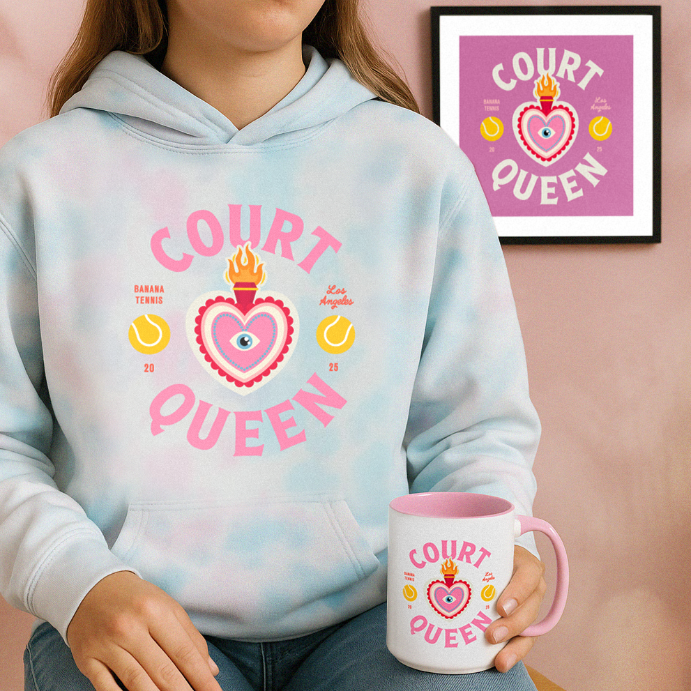 Person wearing a hoodie and holding a mug with 'Court Queen' design, framed picture in the background.