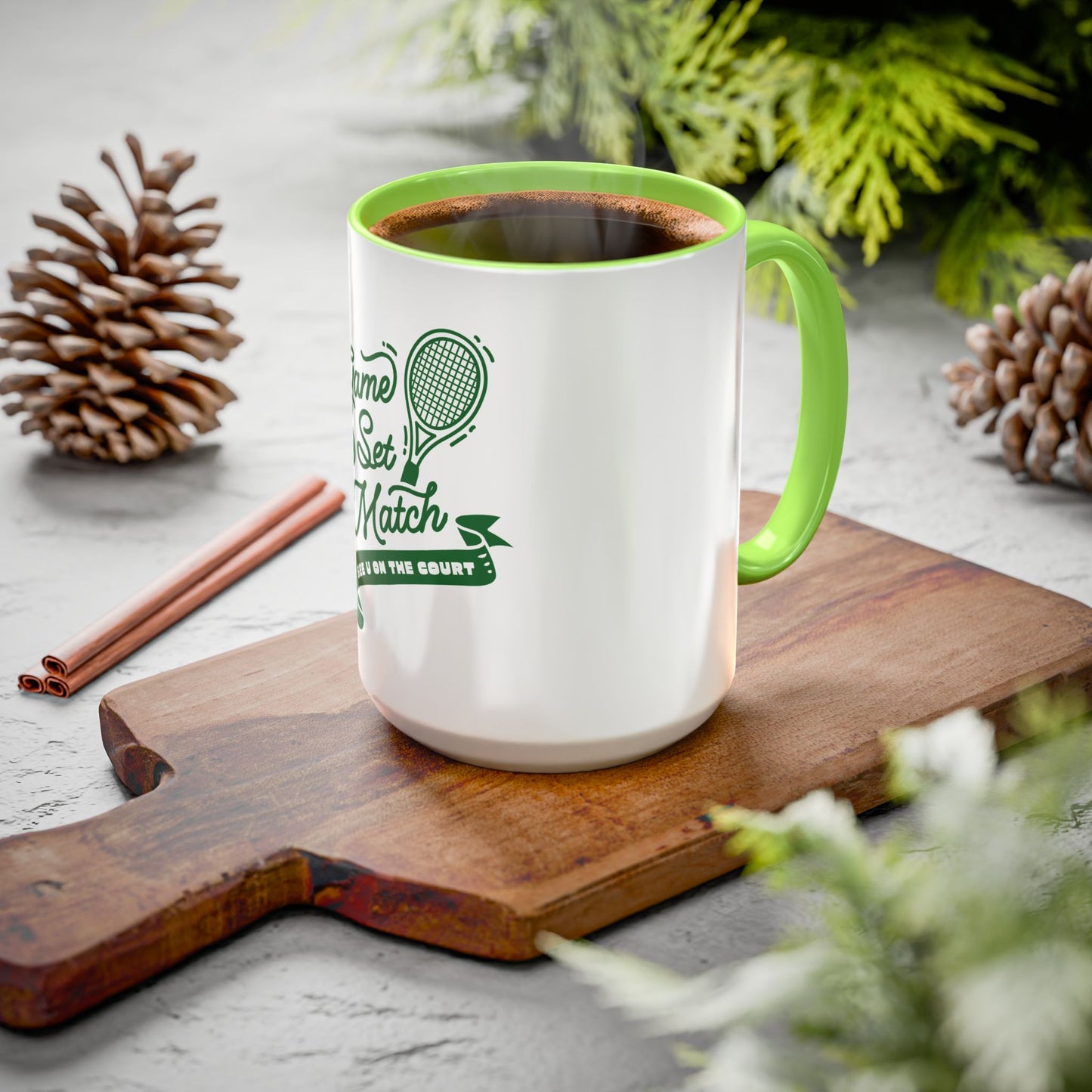 White mug with green handle and text on a wooden cutting board with decorative elements