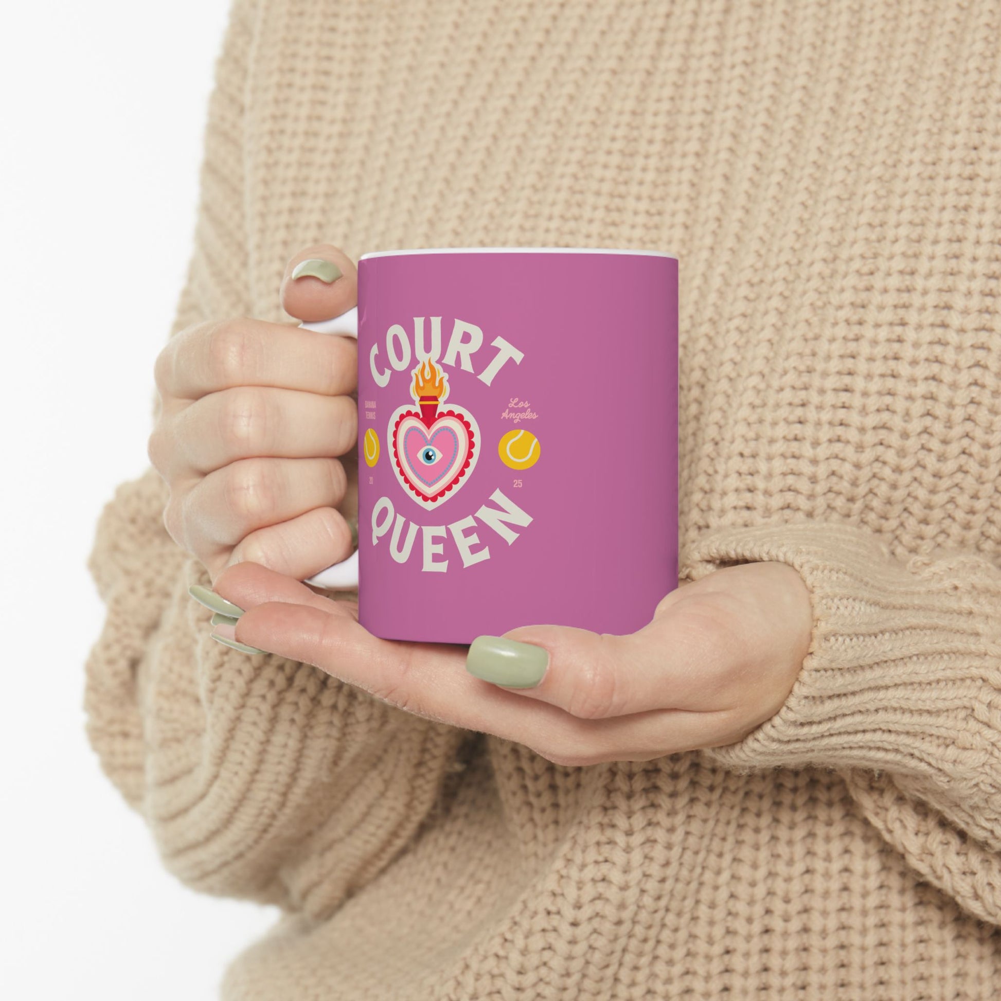 Person holding a purple mug with 'Court Queen' design