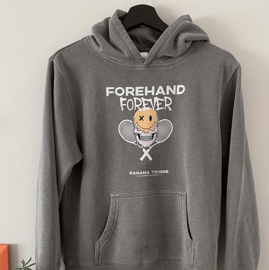 Gray hoodie with 'Forehand Forever' graphic design on a hanger against a white wall.