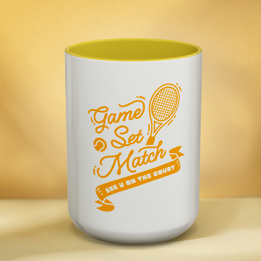 White mug with yellow interior and 'Game Set Match' text on a yellow background
