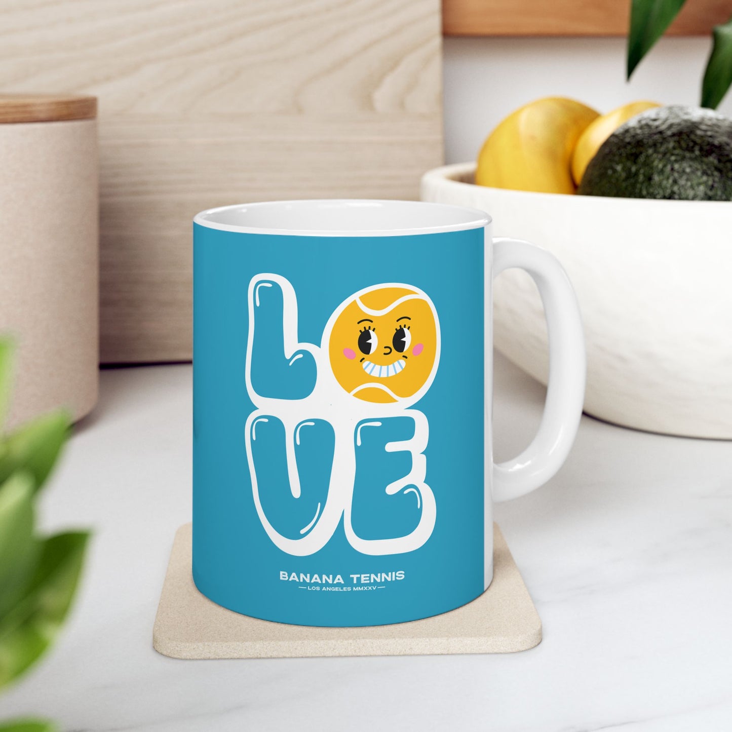 Blue mug with a banana-themed design on a white surface
