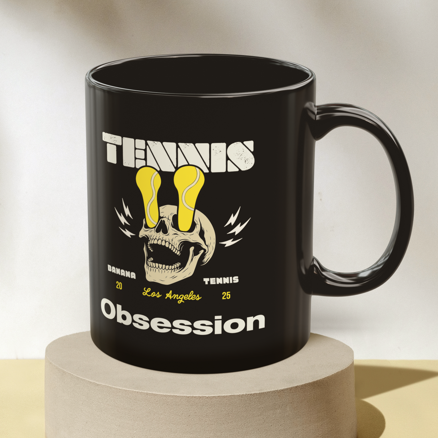 Black mug with graphic design on a beige background