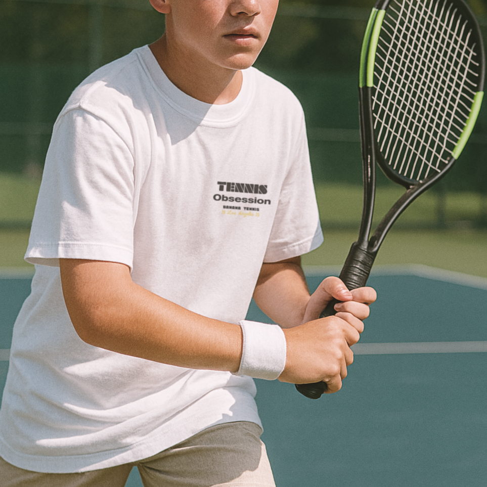 Young boy holding a tennis racket on a tennis court