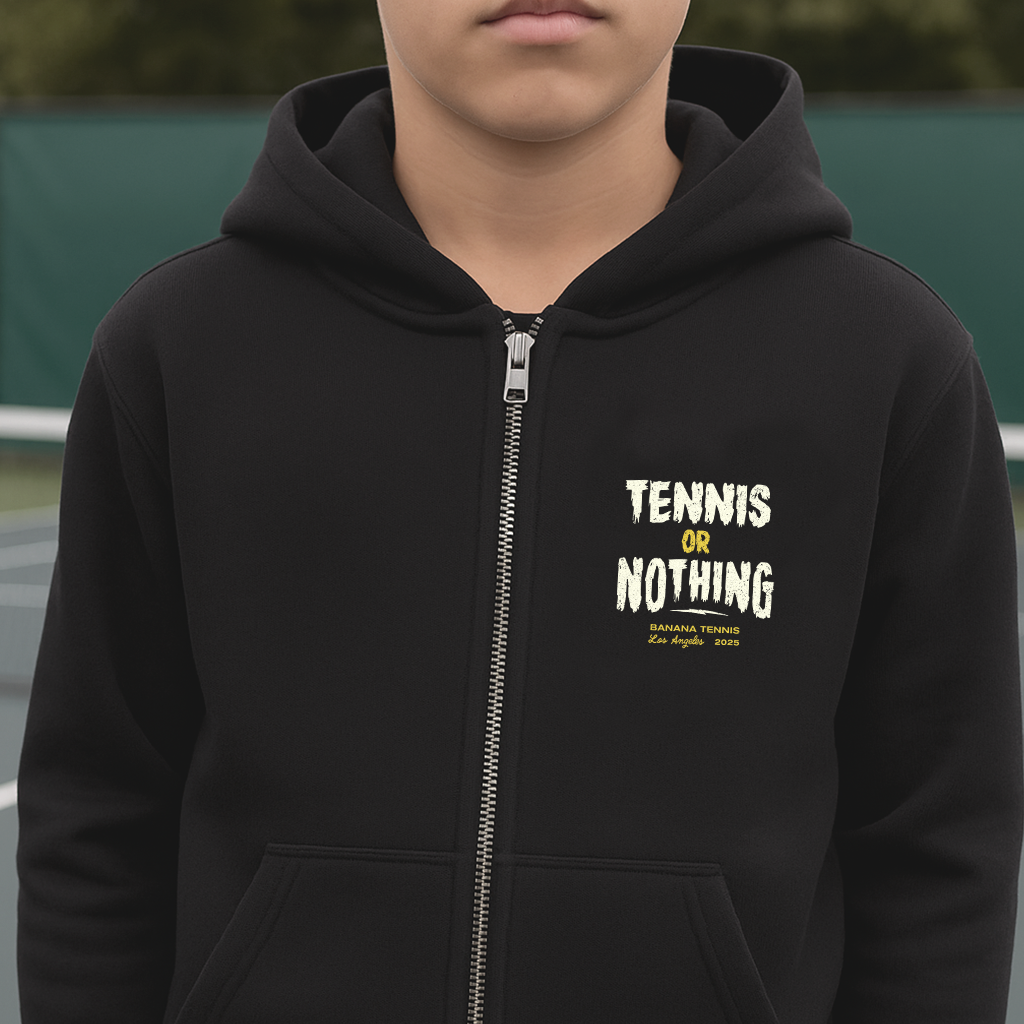 Person wearing a black hoodie with 'Tennis or Nothing' text on tennis court background